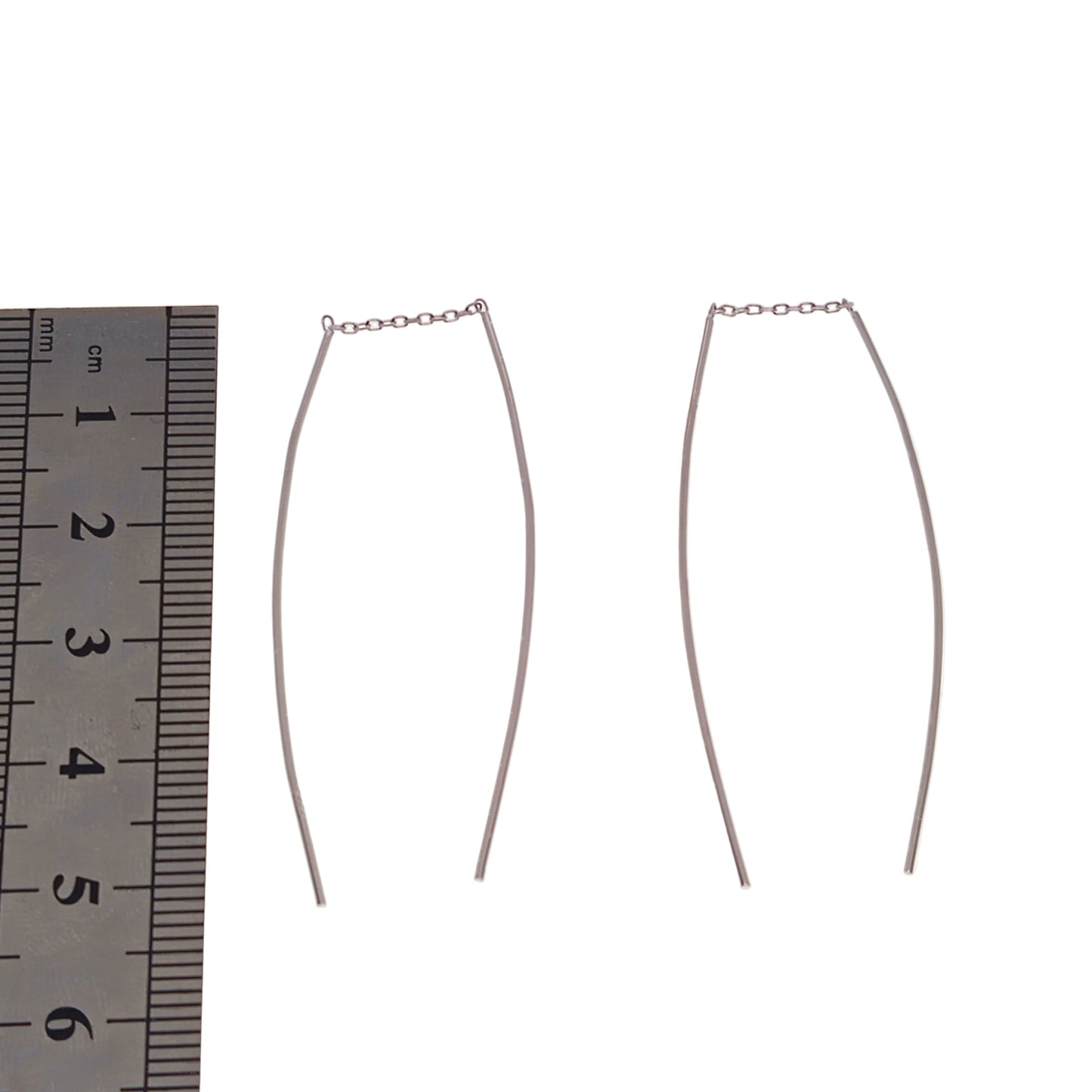Sterling silver threader earrings with a ruler on a white background