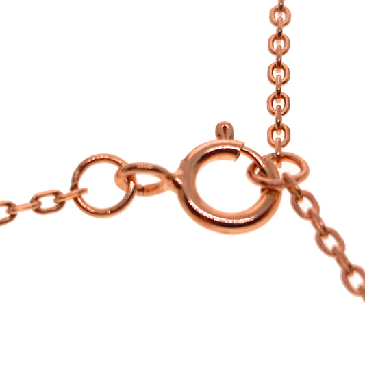Close-up of a rose gold chain with clasp on a white background