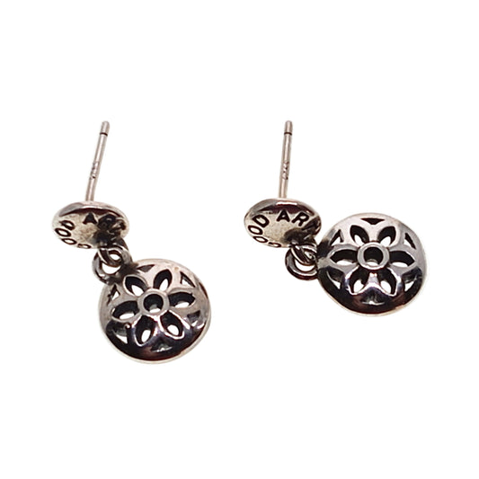 Pair of silver floral earrings on a white background