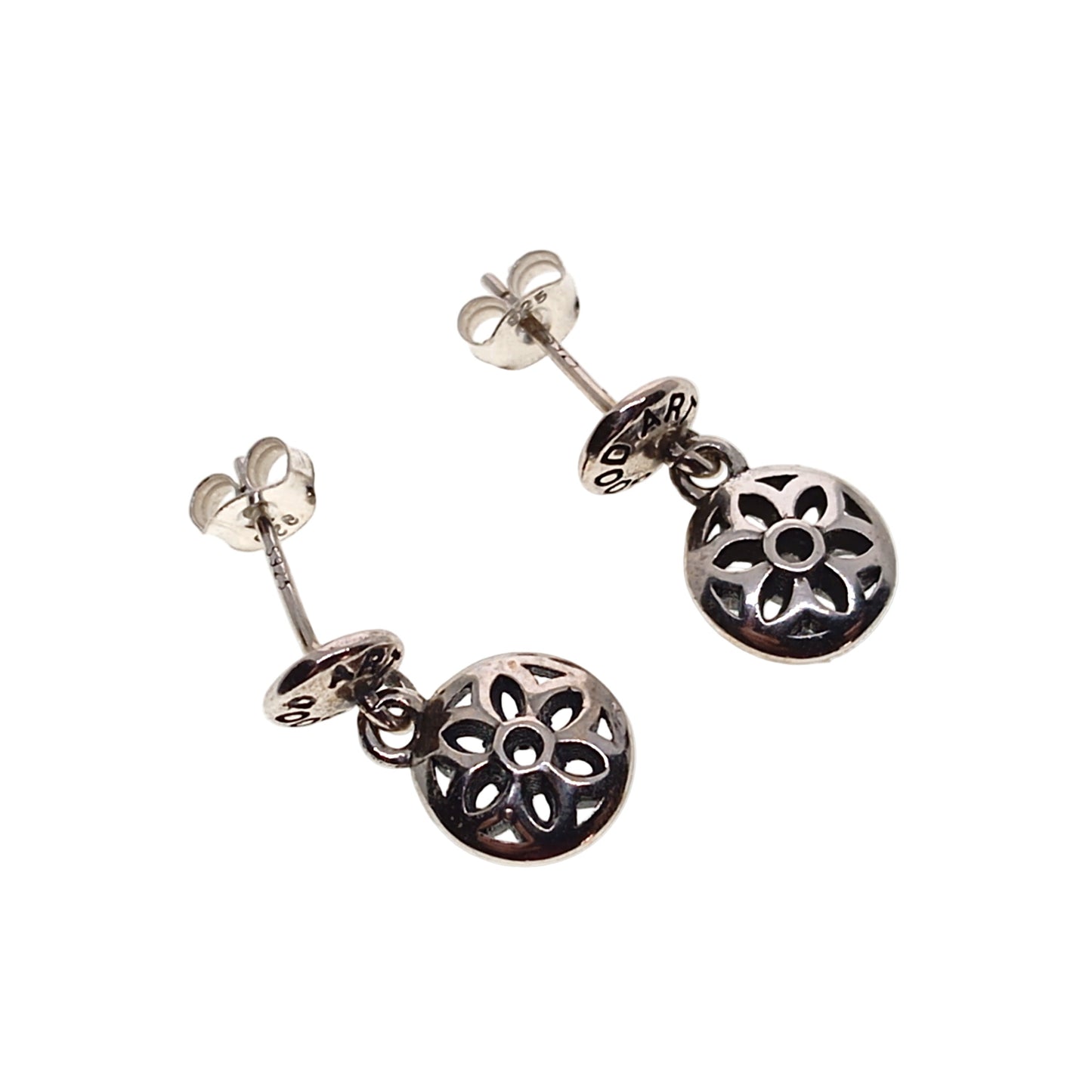 Pair of silver earrings with floral designs on a white background