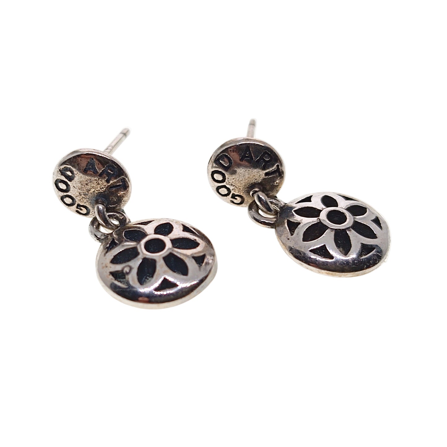 Pair of silver floral earrings on a white background