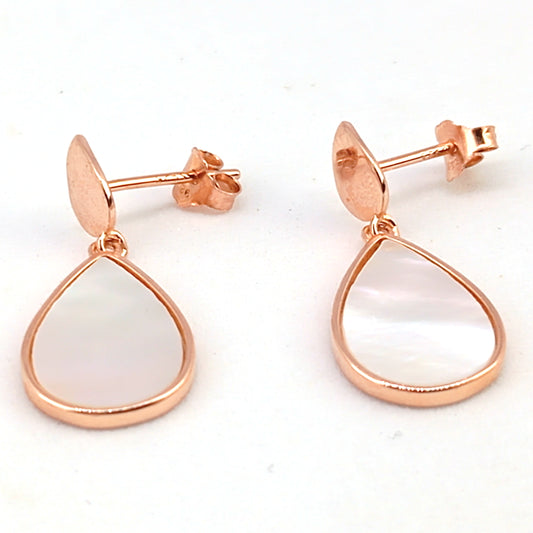 Rose gold earrings with teardrop-shaped white stones on a white background