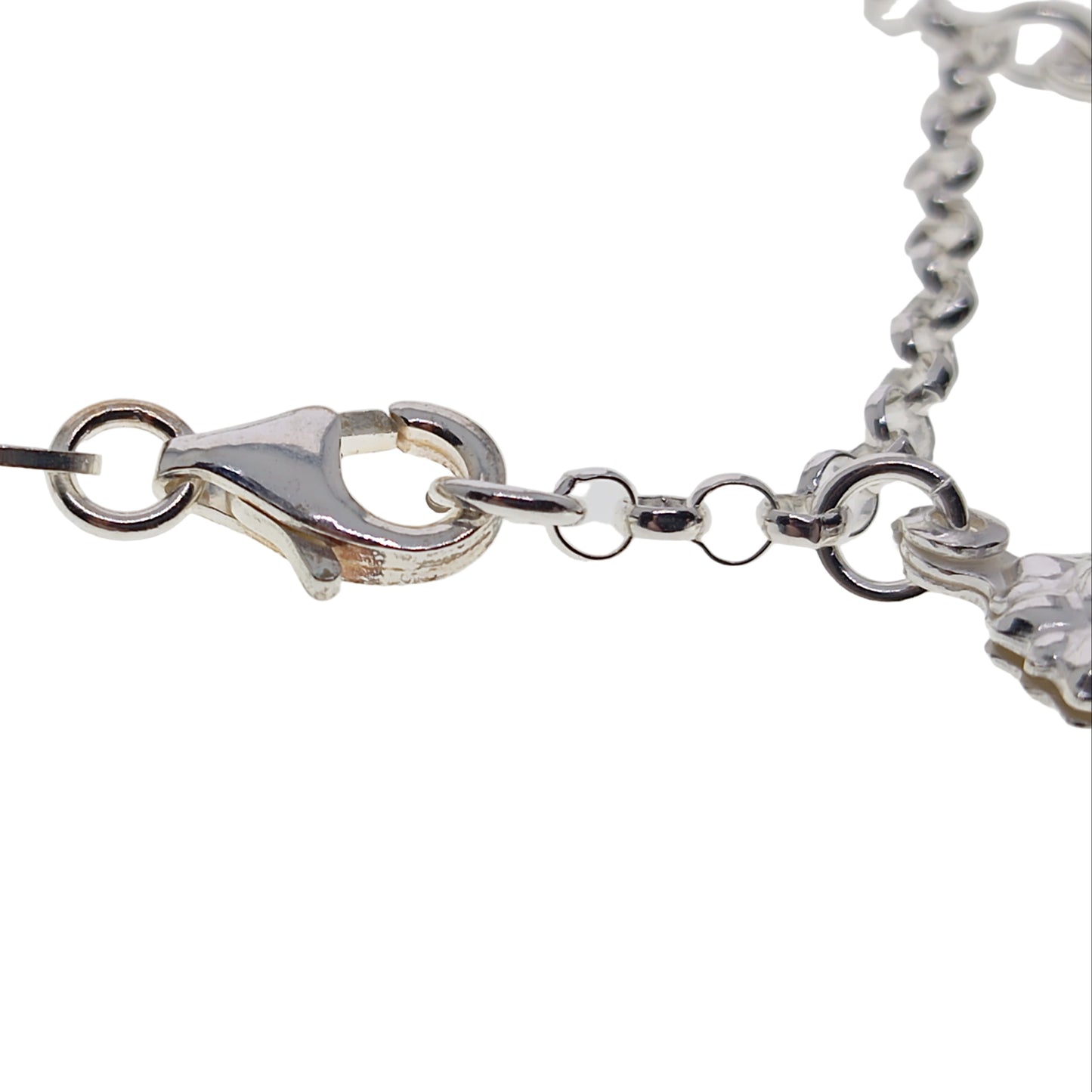 Silver bracelet with a clasp on a light gray background