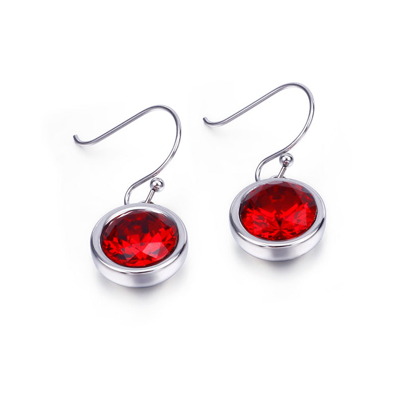 Silver earrings with red gemstones on a white background