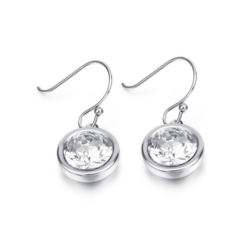 Silver earrings with clear gemstones on a white background