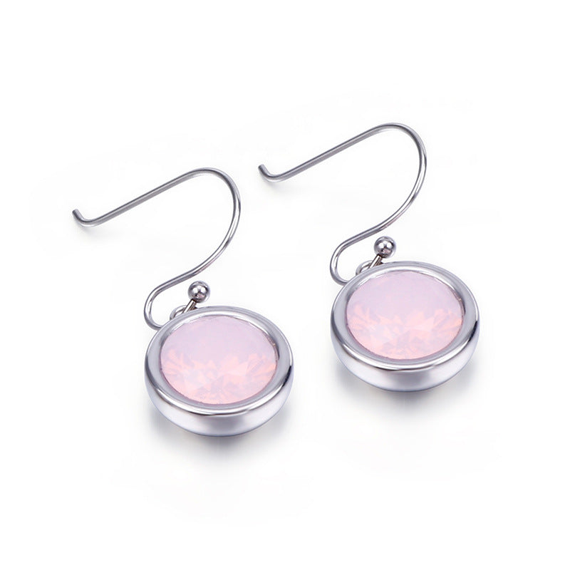 Silver earrings with pink gemstones on a white background