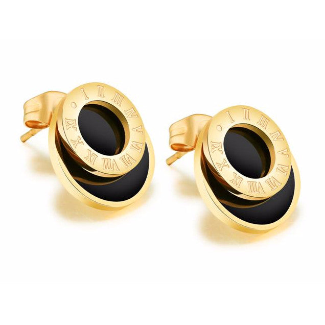 Gold and black earrings on a white background