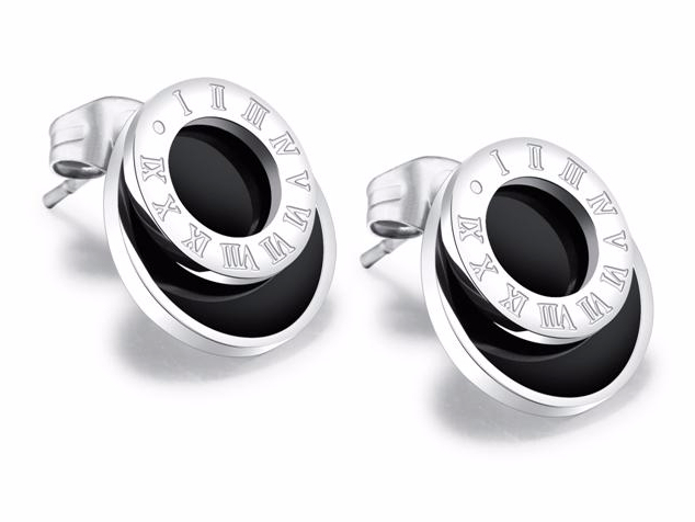 Pair of silver earrings with black stones on a white background