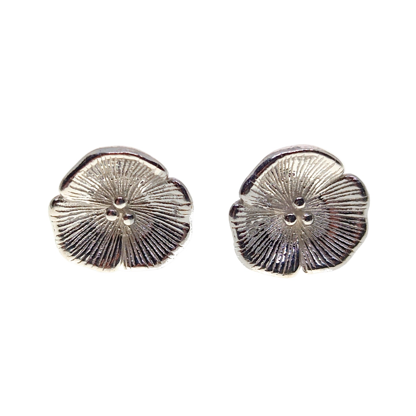 Pair of silver floral earrings on a white background