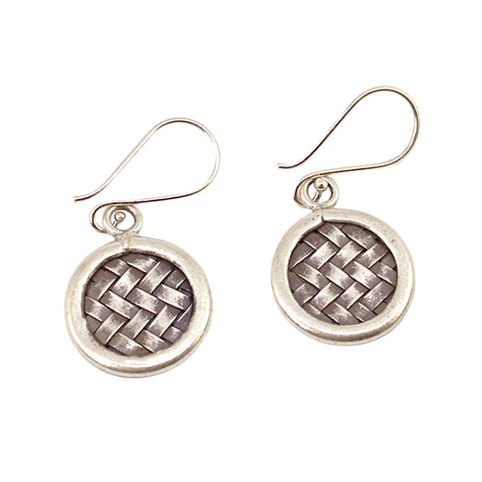 Pair of silver woven earrings on a white background