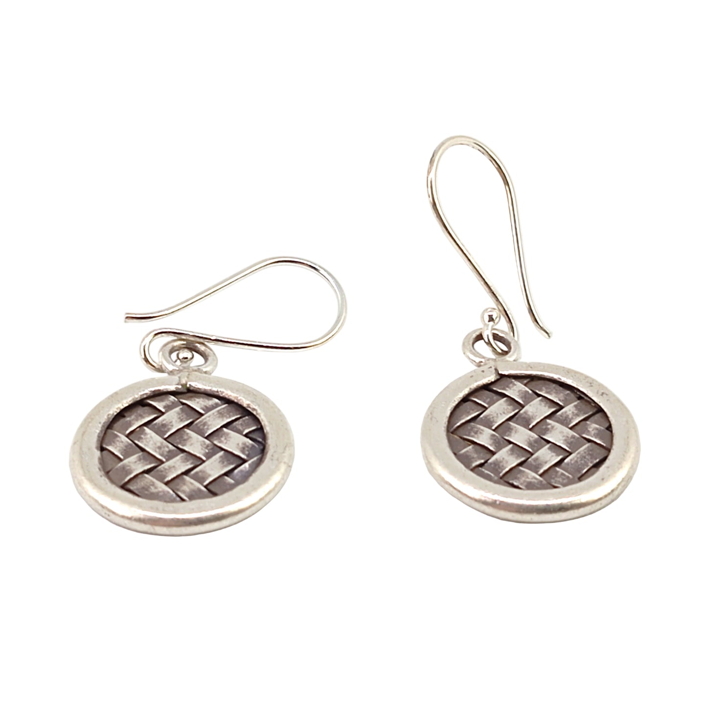 Pair of silver earrings with woven design on a white background